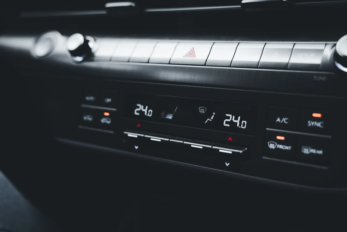 Car climate controls with illuminated temperature displays, buttons and status indicators