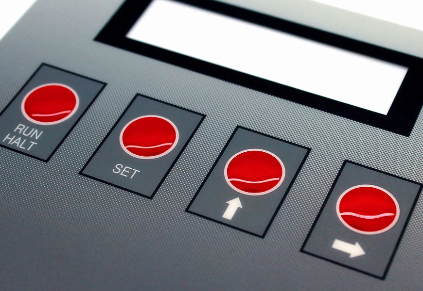 Printed control overlay with a clear rectangular display window, black border and four red keys