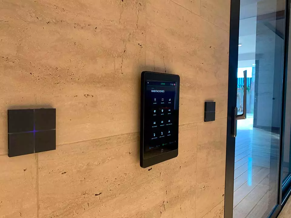 Wall-mounted home-control touchscreen between two square control plates