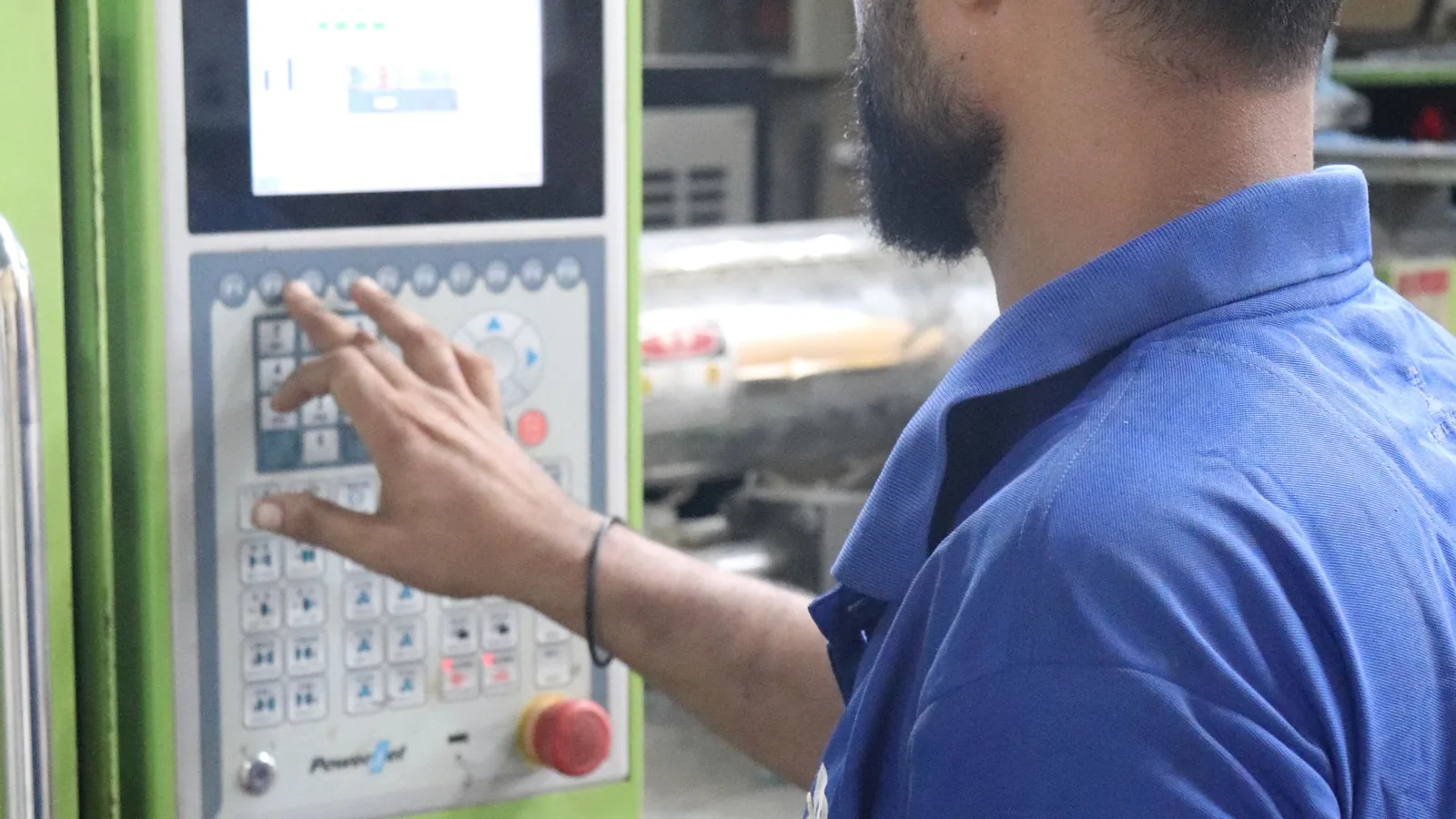 Operator using an industrial machine control panel