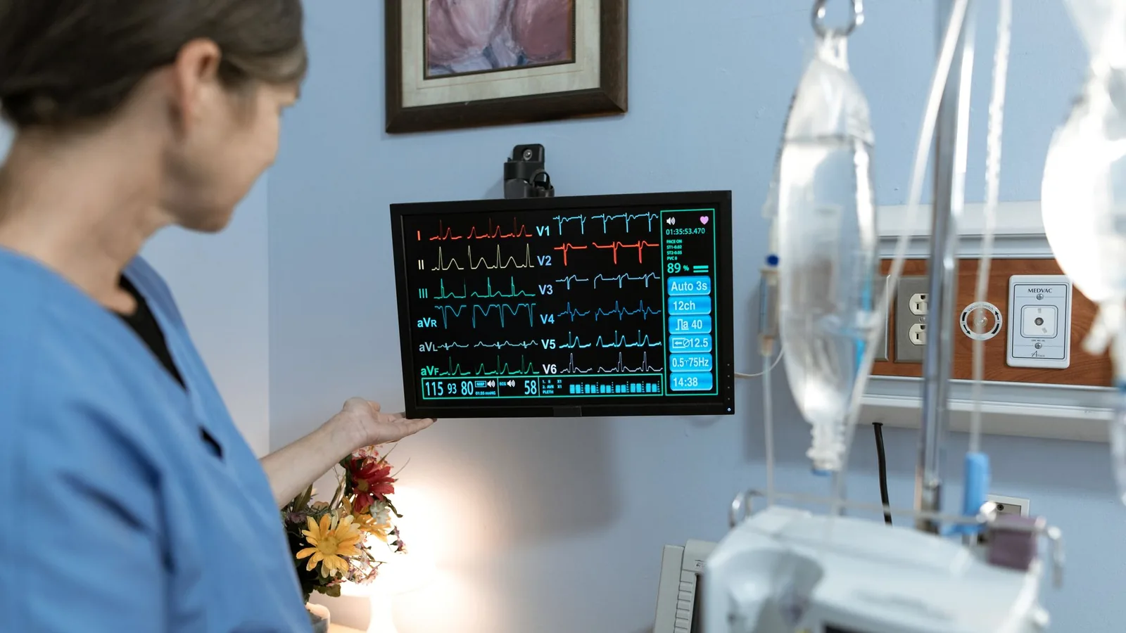 Nurse monitoring medical equipment in a patient-care setting
