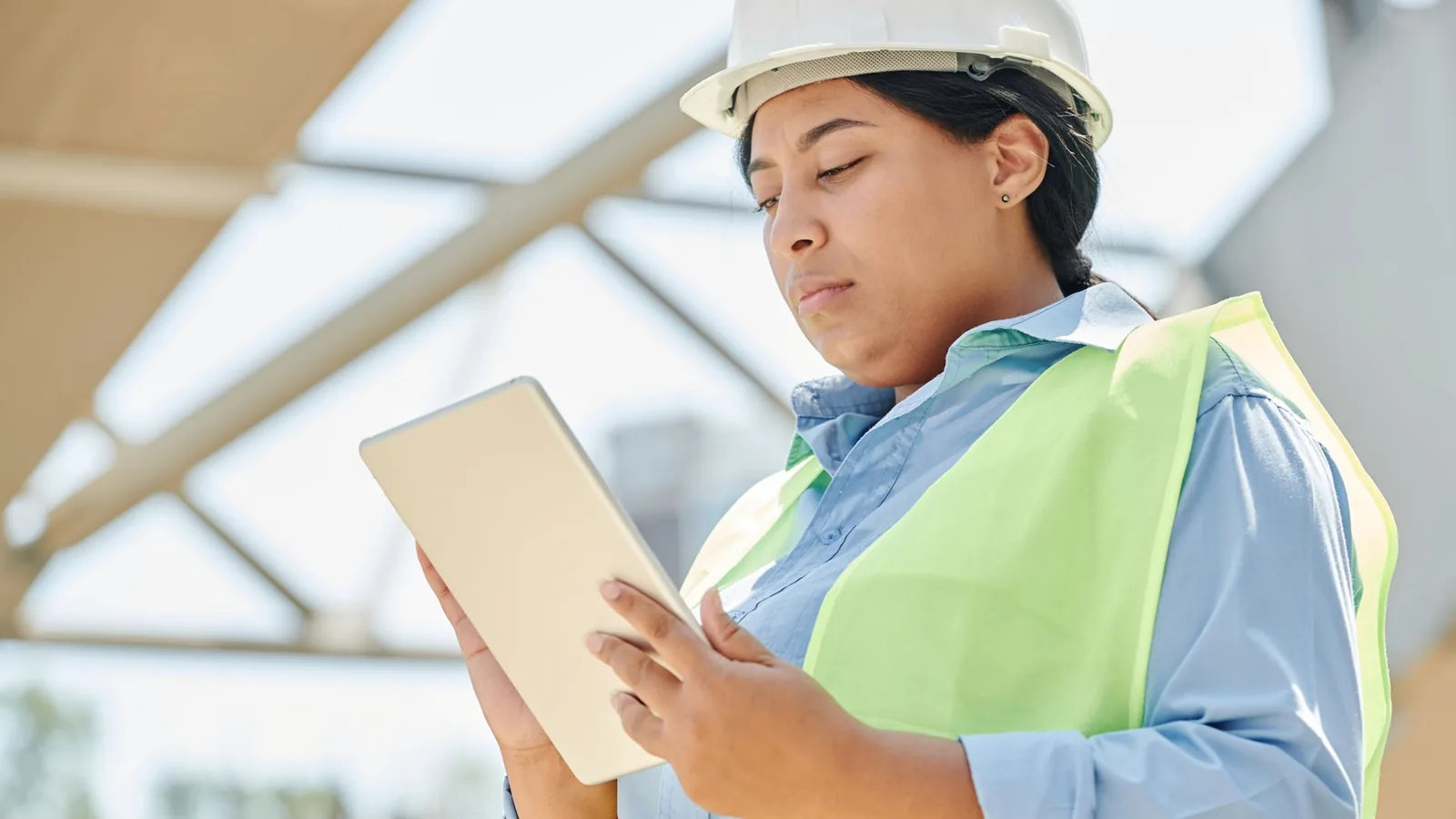 Engineer using a tablet at an outdoor construction site