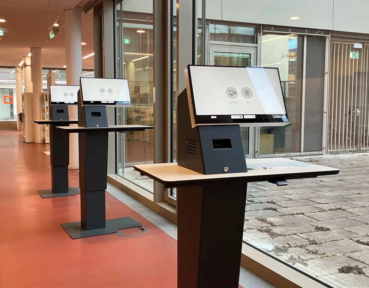 Self-service library kiosks with active touchscreens, dark bezels and front openings
