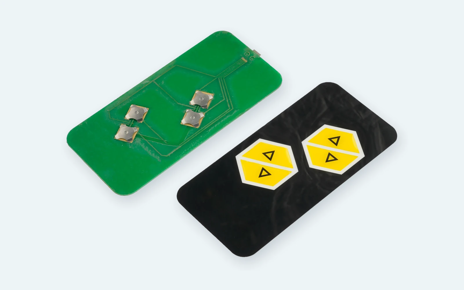 Real membrane switch assembly showing four exposed metal domes beside its printed graphic overlay