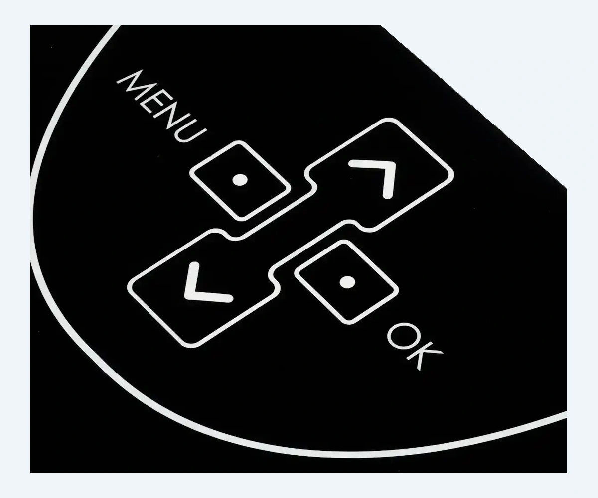 Printed menu, arrow and OK operating legends on a black control faceplate