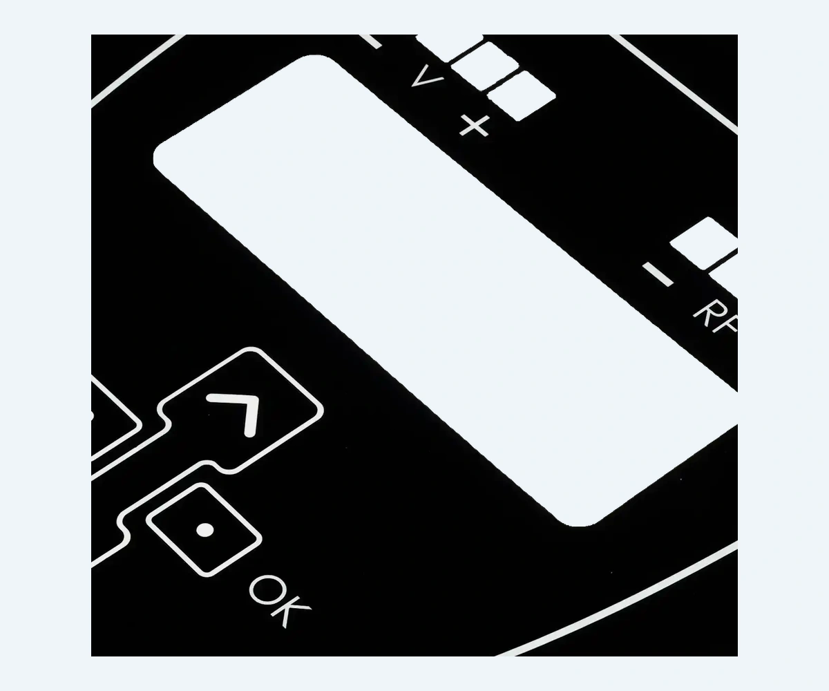 Rectangular display opening and surrounding printed border on a black control faceplate