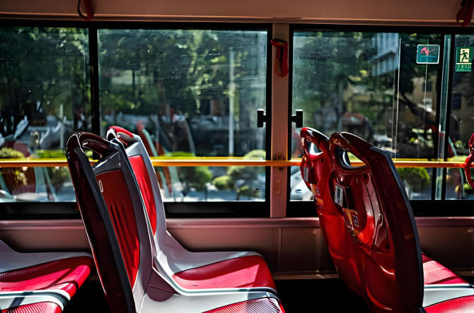 Rows of passenger seats inside a city bus