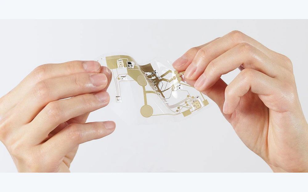 Flexible printed circuit being bent between two hands