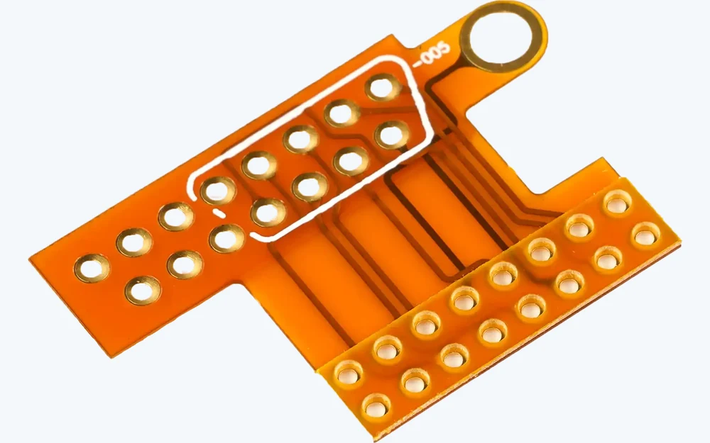 Real flexible PCB interconnect board with routed copper traces, contact pads, and mounting ring