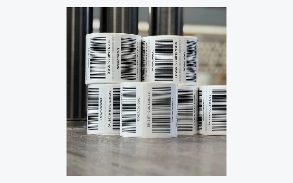 Rolls of printed barcode labels with distinct alphanumeric identifiers