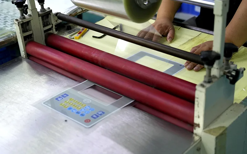 Roller lamination of a printed membrane switch panel